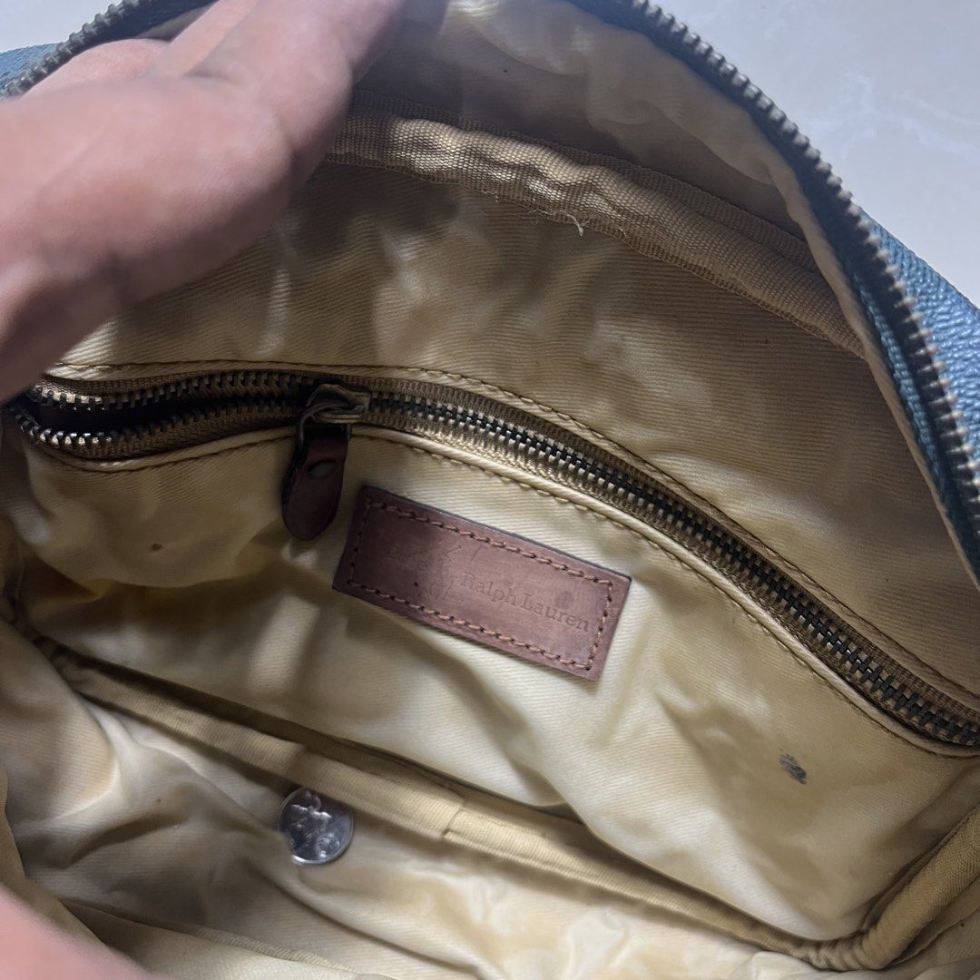 Ralph Lauren Plaid Pouch Bag (Category: Purses & Pouches) located in Manila. Submitted by direcmampu37948 (Listing ID 1459918129, Image 3). Description: - Classic Ralph Lauren plaid design - Genuine leather accents on zipper and handle - Interior zippered pocket for secure storage - Perfect for travel or everyday essentials - Shows some signs of wear on leather and zipper, adding character.
