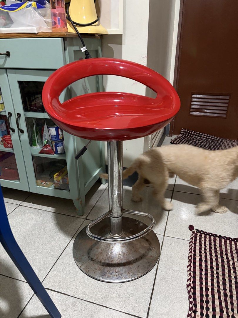 Red Bar Stool (Category: Chairs) located in Marikina City. Submitted by majocalubay (Listing ID 1460058236, Image 2). Description: - Red bar stool with curved seat and backrest - Adjustable height with lever - 360-degree swivel - Chrome metal base and footrest - Perfect for kitchen counters or bar areas - Minor signs of wear on the base but can be repainted if needed.