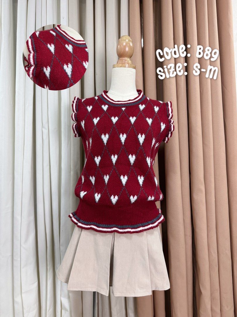 Red Heart Knitted Vest (Category: Sleeveless) located in Subic. Submitted by majoquindo (Listing ID 1460035337, Image 1). Description: - Adorable red knit vest top - Features a charming diamond argyle pattern with white hearts - Ruffled sleeves and hemline with stylish striped trim - Versatile: pairs well with skirts or pants - Size: S-M.