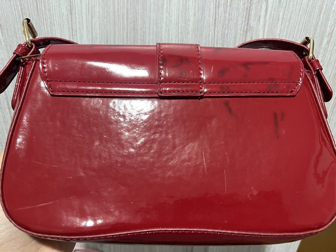 Red Patent Leather Shoulder Bag with Gold Hardware (Category: Luxury Bags & Wallets) located in Quezon City. Submitted by roastedalmondmt (Listing ID 1460054866, Image 2). Description: - Shiny red shoulder bag - Features a gold buckle detail on the front flap - interchangeable short and long strap - Minor scuff marks and smudges on the back and sides, black stain nadikit sa black leather skirt Guidelines: - Payment first policy - No return, no ex
