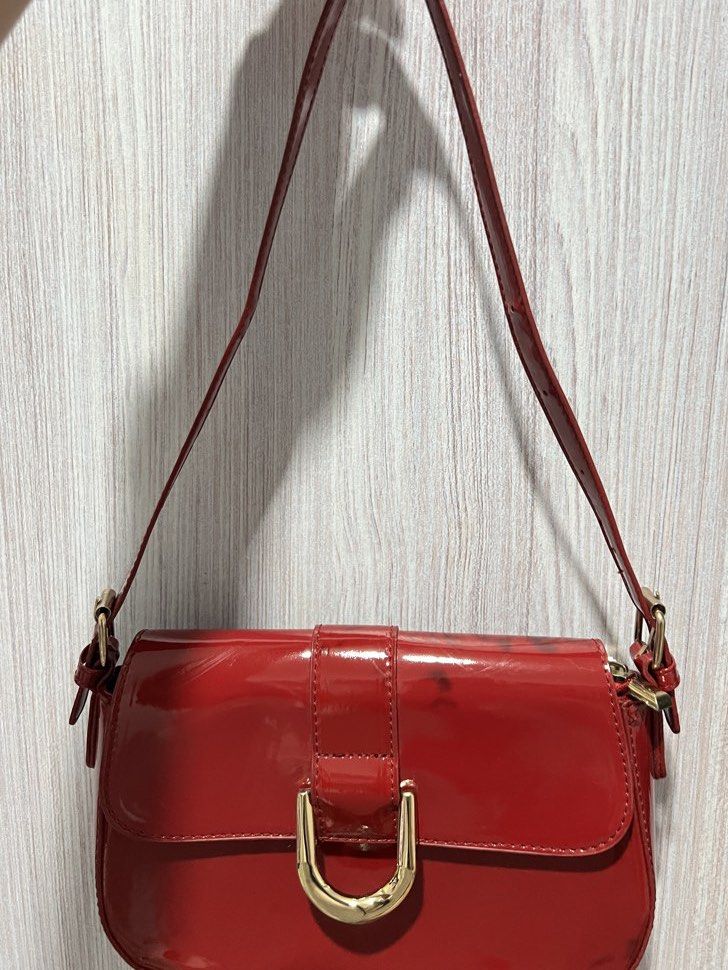 Red Patent Leather Shoulder Bag with Gold Hardware (Category: Luxury Bags & Wallets) located in Quezon City. Submitted by roastedalmondmt (Listing ID 1460054866, Image 1). Description: - Shiny red shoulder bag - Features a gold buckle detail on the front flap - interchangeable short and long strap - Minor scuff marks and smudges on the back and sides, black stain nadikit sa black leather skirt Guidelines: - Payment first policy - No return, no ex