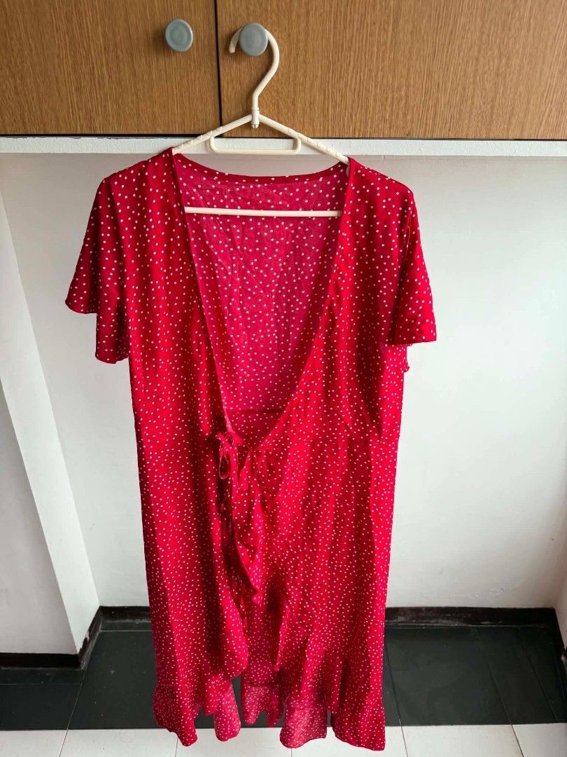 Red Polka Dot Wrap Dress with Ruffle Hem (Category: Dresses) located in Manila. Submitted by atozstuff (Listing ID 1460095213, Image 2). Description: - Cute red wrap dress - White polka dot pattern - Short flutter sleeves - Adjustable tie waist - Flowy ruffle hem - Ideal for casual outings or beach days - Easy to wear and style.