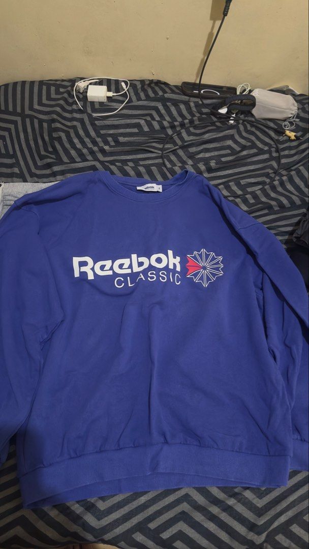 Reebok Classic Crewneck Sweatshirt (Category: Coats, Jackets and Outerwear) located in Plaridel. Submitted by estanislao.noveno (Listing ID 1459909987, Image 1). Description: - Classic Reebok crewneck sweatshirt - Features iconic Reebok Classic logo on the front - Ribbed cuffs and hem for a comfortable fit - Ideal for casual wear and everyday styling.