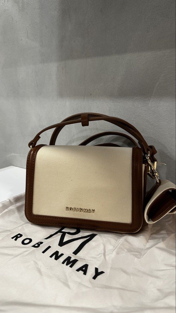 Robinmay Canvas & Leather Crossbody Bag with Pouch (Category: Cross-body Bags) located in Rizal. Submitted by dumbchowdy (Listing ID 1460038137, Image 3). Description: - Cute Robinmay crossbody bag - Cream canvas with brown leather trim - Comes with matching coin pouch - Includes dust bag - Adjustable strap - Magnetic closure - Inside zip pocket - Great for everyday use - taiwan brand.