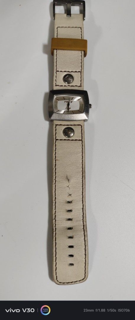 Roxy Watch with Leather Strap (Category: Women's Watches) located in Manila. Submitted by roblazo25 (Listing ID 1459971186, Image 2). Description: - Roxy watch - Cream-colored leather strap with signs of wear (marks, creasing) - Rectangular watch face with white dial - Features Roxy logo - Buckle closure - Perfect accessory for everyday wear.
