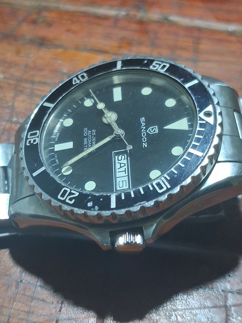 Sandoz Automatic Dive Watch 100 Meters (Category: Men's Watches) located in Pasig City. Submitted by superjun_ (Listing ID 1460082011, Image 2). Description: - Sandoz automatic watch - Black dial with day and date function - Water resistant up to 100 meters - Stainless steel bracelet - Shows some signs of wear on bezel and bracelet - Solid timepiece for everyday wear or diving -hard to find .