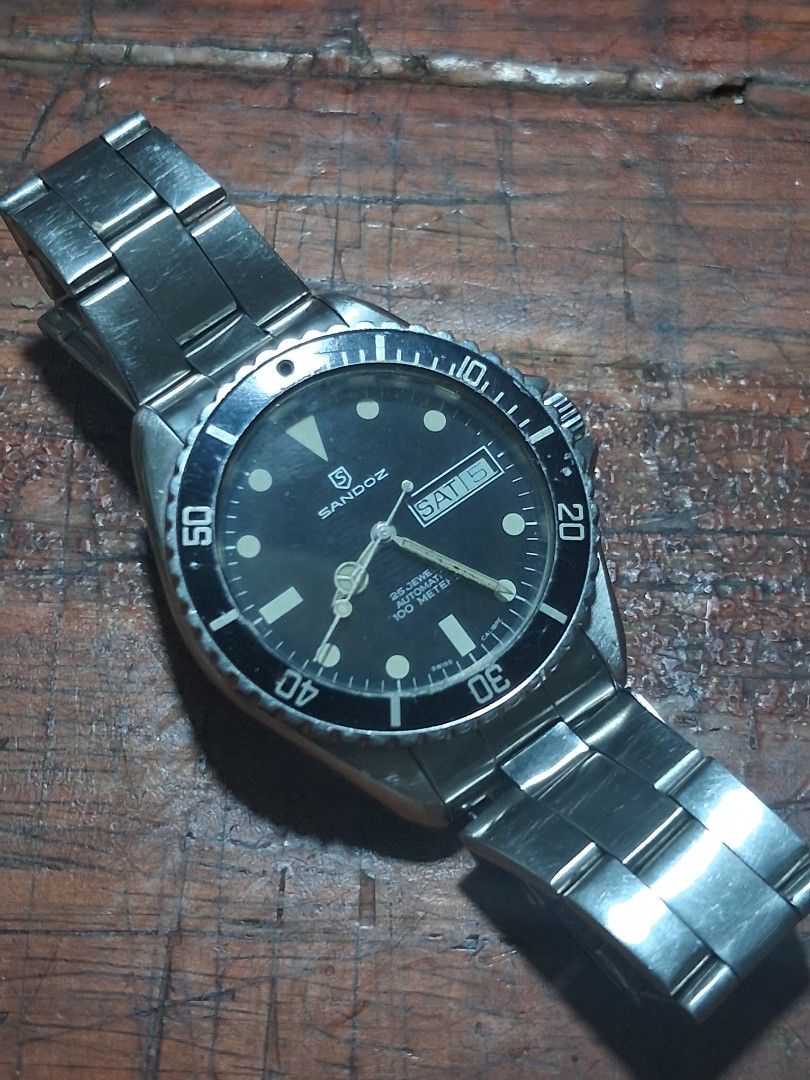 Sandoz Automatic Dive Watch 100 Meters (Category: Men's Watches) located in Pasig City. Submitted by superjun_ (Listing ID 1460082011, Image 3). Description: - Sandoz automatic watch - Black dial with day and date function - Water resistant up to 100 meters - Stainless steel bracelet - Shows some signs of wear on bezel and bracelet - Solid timepiece for everyday wear or diving -hard to find .