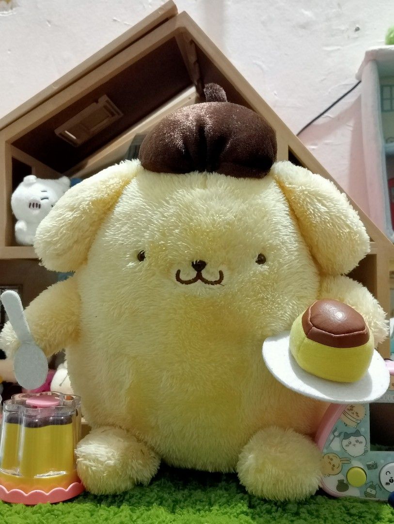 Sanrio Pompompurin Plush Toy with Pudding (Category: Plushies & Soft Toys) located in Caloocan City. Submitted by thecanceri83884 (Listing ID 1459982538, Image 1). Description: - Adorable Pompompurin plushie - Comes with a mini pudding on a plate and a spoon - Includes a tiny pudding cup accessory - Ideal for Sanrio fans and collectors - Soft and cuddly material.