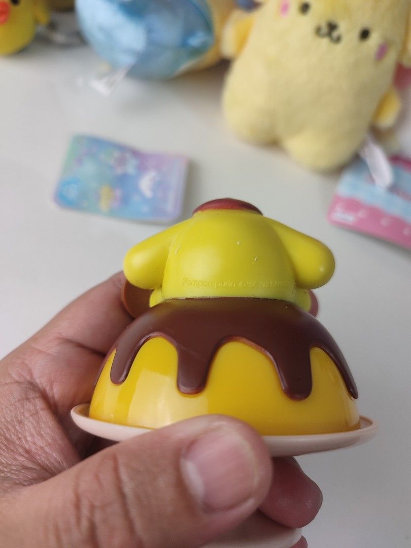 Sanrio Pompompurin Pudding Cafe Figure (Category: Designer & Blind Box Toys) located in Manila. Submitted by epicmountain-f20453 (Listing ID 1460103423, Image 2). Description: - Adorable Pompompurin figure designed as a pudding. - Part of the exclusive Kitty & Friends Cafe collection. - Features a removable pudding top for added fun. - Ideal for Sanrio enthusiasts and collectors. - A charming addition to any desk or shelf decor..