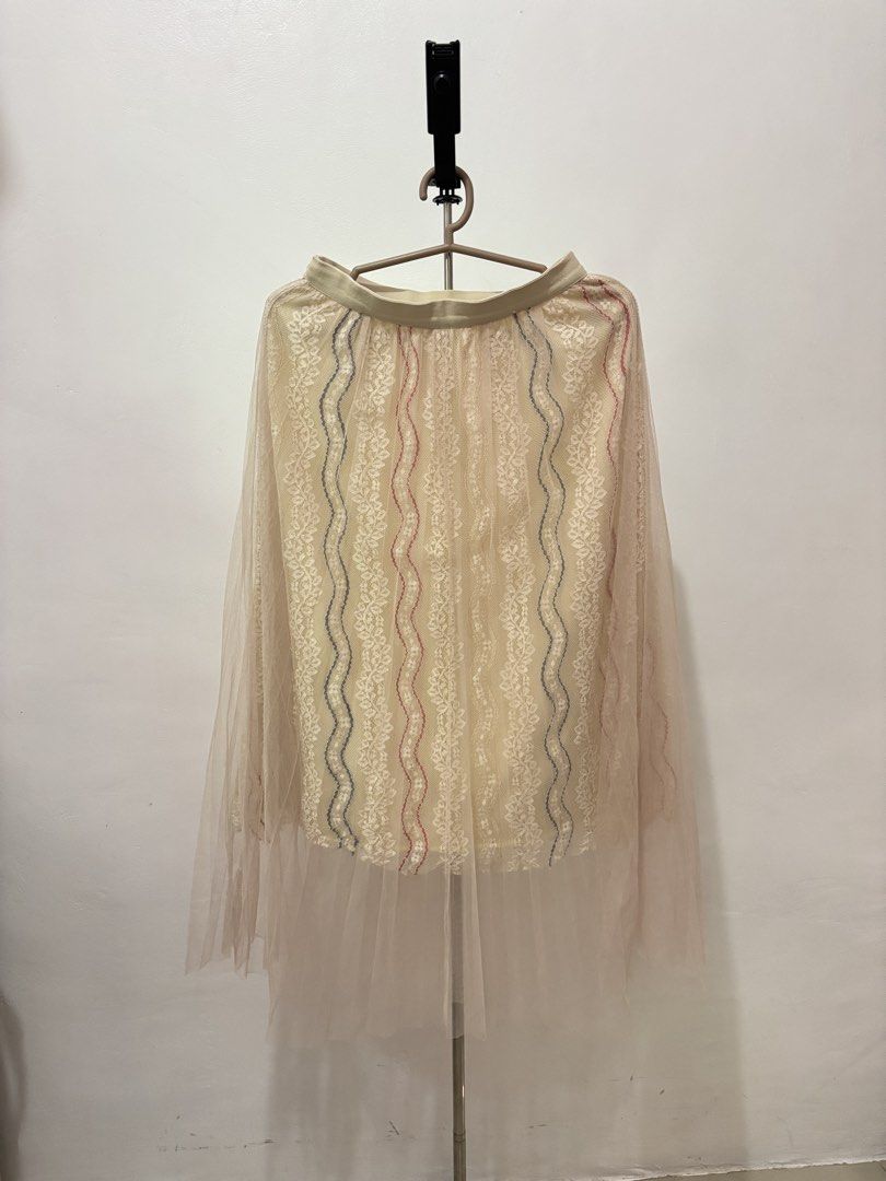Sheer Lacey Midi Skirt | Preloved (Category: Skirts) located in Taguig. Submitted by hi_itsziana (Listing ID 1459978516, Image 1). Description: - Elegant cream lace midi skirt - Features delicate red and blue vertical embroidery - Comfortable elastic waistband - Perfect for dressing up or down, pairs beautifully with a simple top - Preloved.