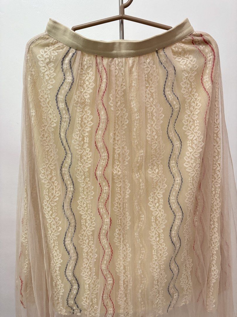 Sheer Lacey Midi Skirt | Preloved (Category: Skirts) located in Taguig. Submitted by hi_itsziana (Listing ID 1459978516, Image 2). Description: - Elegant cream lace midi skirt - Features delicate red and blue vertical embroidery - Comfortable elastic waistband - Perfect for dressing up or down, pairs beautifully with a simple top - Preloved.