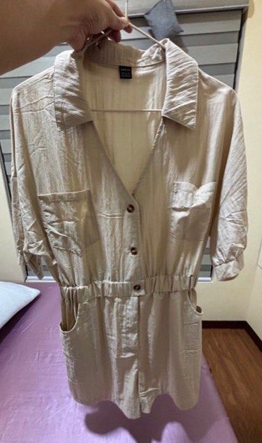 Shein Beige Linen Blend Button-Up Short Jumpsuit (Category: Jumpsuits) located in Las Pinas. Submitted by drecessionista (Listing ID 1460056207, Image 2). Description: - Casual and chic beige jumpsuit - Short sleeves with a collared neckline - Button-up front with cinched elastic waist - Two chest pockets and side pockets - Comfortable linen blend fabric - Ideal for a relaxed day out - Fits up to Large.