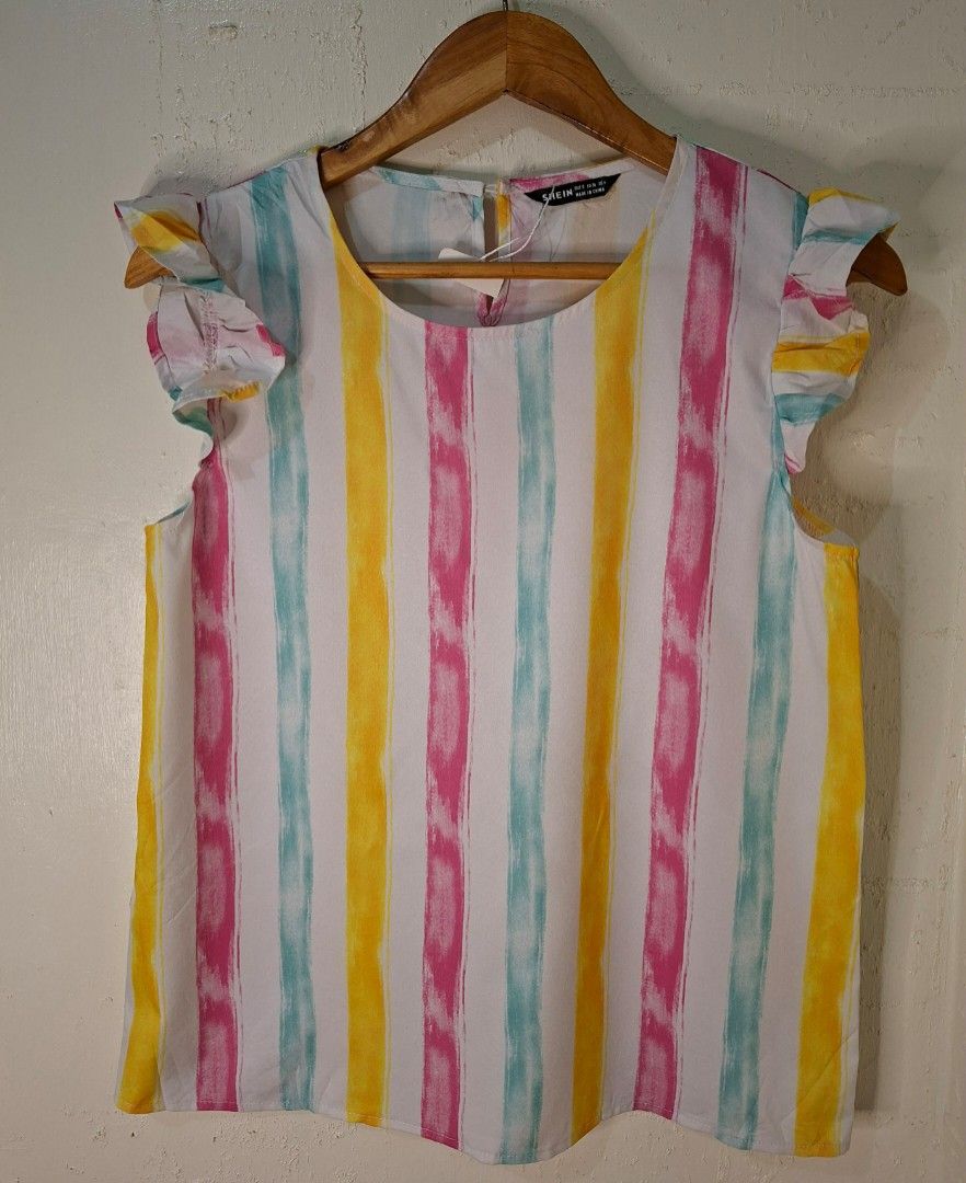 SHEIN MULTICOLOR STRIPED BLOUSE (Category: Activewear) located in Caloocan City. Submitted by pvaliao (Listing ID 1459933288, Image 3). Description: SHEIN multicolor striped blouse featuring a bright, dopamine inspired palette of yellow, pink, turquoise vertical watercolor stripes. It is designed with a classic round neckline, lightweight woven fabric, and playful ruffle flounce cap sleeves, and a small keyhole button closure at the back of the n