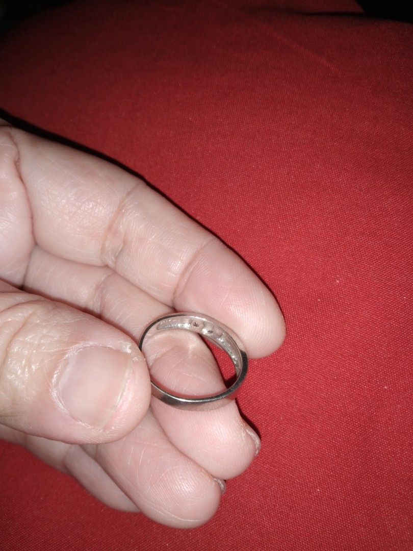 Silver Ring with Small Diamond Accent (Category: Rings) located in Quezon City. Submitted by eidorableshop (Listing ID 1459901404, Image 3). Description: - Simple silver band - Features a small diamond at the center - Adorned with cute heart cut-outs around the band - Estimated size 6 or 7 - Ideal for everyday wear or as a thoughtful gift.