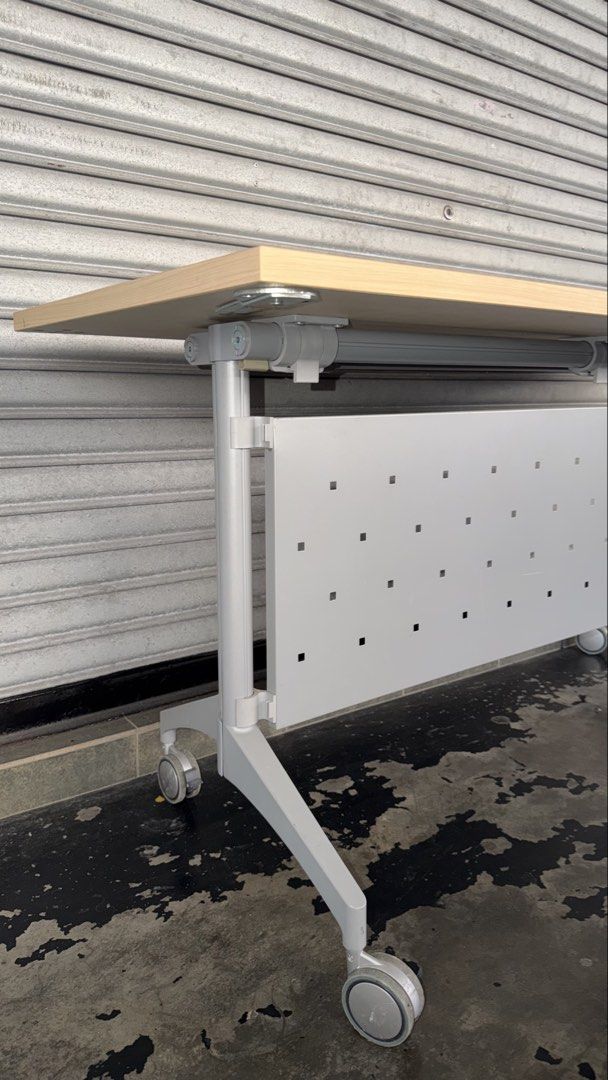 Solid Foldable Office Table with Wheels (Category: Tables & Sets) located in Kuala Lumpur. Submitted by adelaqel (Listing ID 1459999054, Image 3). Description: - Light wood top office table - Sturdy metal frame and base - Easy mobility with wheels - Stylish perforated front panel - Convenient cable management hole - Ideal for office or study - Folds for easy storage.