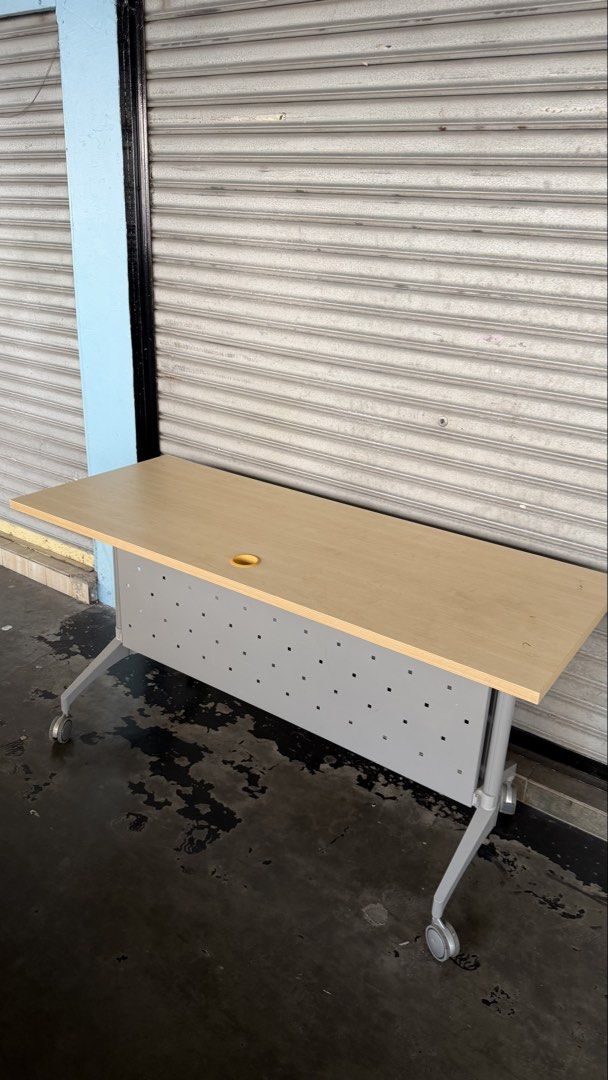 Solid Foldable Office Table with Wheels (Category: Tables & Sets) located in Kuala Lumpur. Submitted by adelaqel (Listing ID 1459999054, Image 1). Description: - Light wood top office table - Sturdy metal frame and base - Easy mobility with wheels - Stylish perforated front panel - Convenient cable management hole - Ideal for office or study - Folds for easy storage.