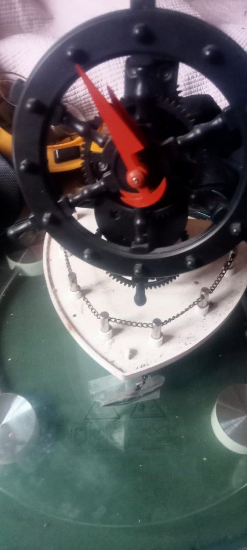 Steampunk Ship Wheel Clock with Gears and Chain (Category: Clocks) located in Paranaque City. Submitted by dimaguilaa94969 (Listing ID 1460054190, Image 1). Description: - Unique ship's wheel design - Features exposed gears and decorative chain - Bright red hands for high contrast - Adds a nautical or steampunk vibe - Excellent conversation starter - Fully functional and works well.