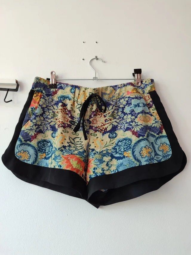 Stradivarius Printed Bohemian Summer Shorts (Category: Shorts) located in Las Pinas. Submitted by drecessionista (Listing ID 1460063327, Image 2). Description: - Vibrant floral print shorts - Black trim on sides and hem - Elastic waistband with drawstring tie - Ideal for lounging or casual outings - Easy to style with basic tops.