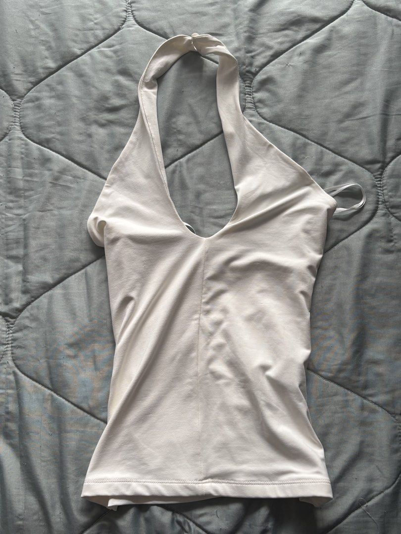 Stradivarius White Halter Neck Top (Category: Sleeveless) located in Paranaque City. Submitted by krispykk (Listing ID 1459975640, Image 1). Description: - Brand: Stradivarius - Style: White Halter Neck Top - Origin: Made in Turkey - Design: Simple and chic - Versatility: Great for layering or wearing on its own - Comfort: Made with comfortable fabric - Wardrobe Essential: A versatile piece for any outfit.