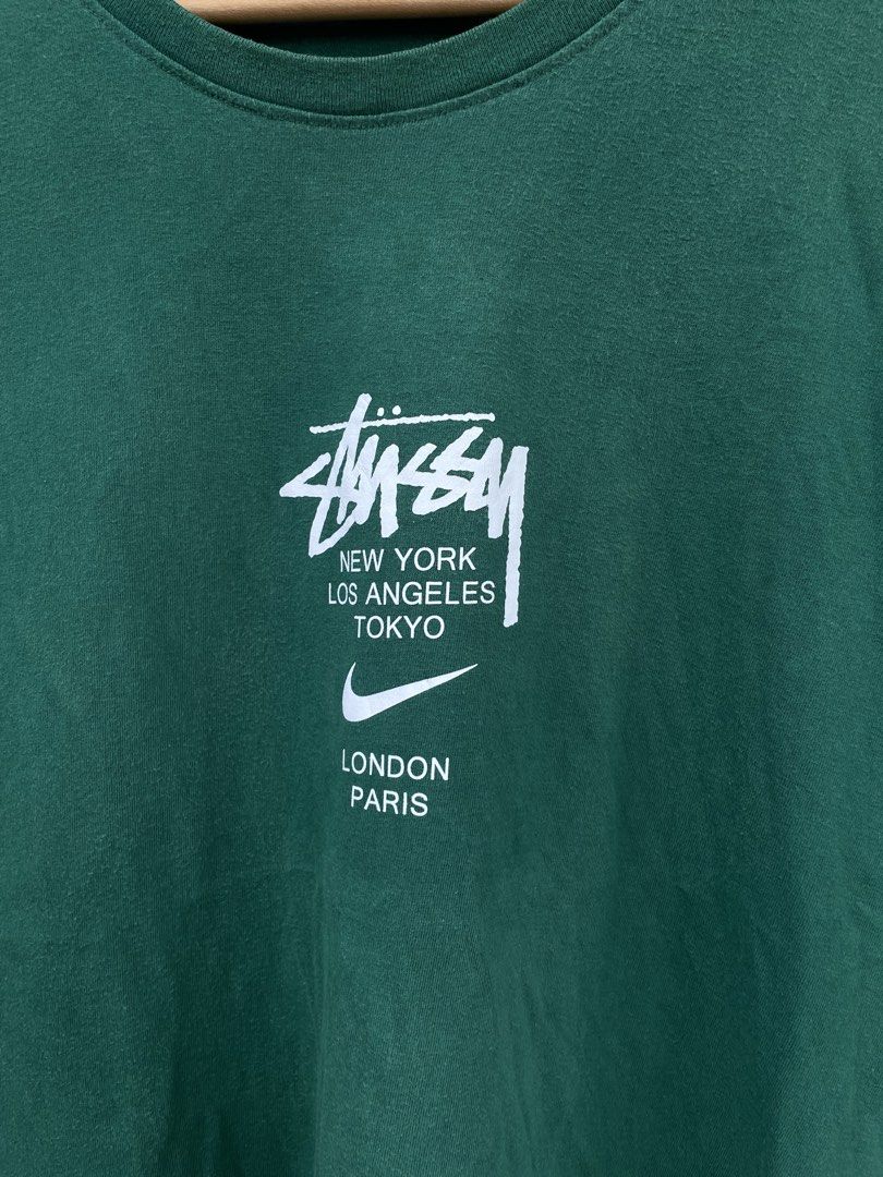 Stussy x nike (Category: Tshirts & Polo Shirts ) located in Quezon. Submitted by thriftedbyandie (Listing ID 1460027199, Image 2). Description: This is a green Nike x Stüssy International T-Shirt featuring the collaborative chest graphic that combines the classic Stüssy script, international city names, and the Nike Swoosh ₱600 plus sf📥📥.