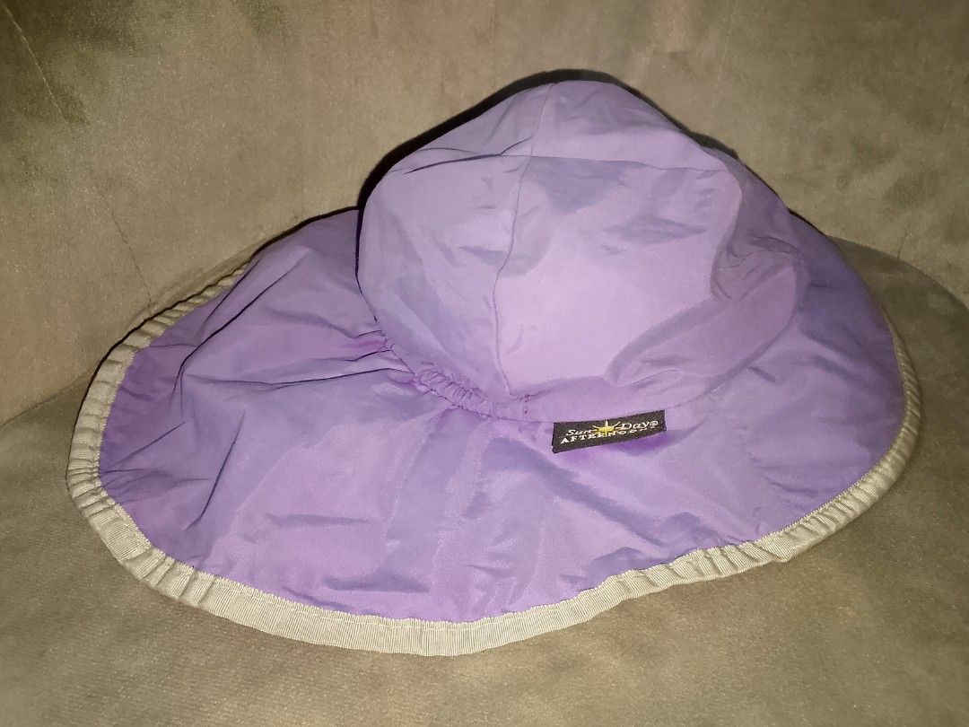 Sunday Afternoon Widebrim Sun Hat (Category: Hats & Beanies) located in Binangonan. Submitted by yuristalin888 (Listing ID 1459947415, Image 2). Description: Stay protected under the sun with this stylish purple sun hat from Sunday Afternoons. Brand & Design: Features the official Sunday Afternoons logo tag and a wide brim accented with a contrasting light trim. Functionality: Equipped with an adjustable chin strap and cord lock to keep the hat s