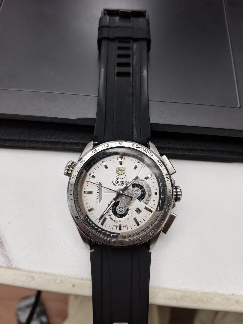 TAG Heuer Grand Carrera Chronograph Automatic Watch (Category: Luxury Watches) located in Manila. Submitted by busines58275 (Listing ID 1460105315, Image 1). Description: - TAG Heuer Grand Carrera - Automatic movement - Chronograph function - White dial with silver accents - Black rubber strap - Signs of wear on case and bezel - Watch is functional - Selling as is.