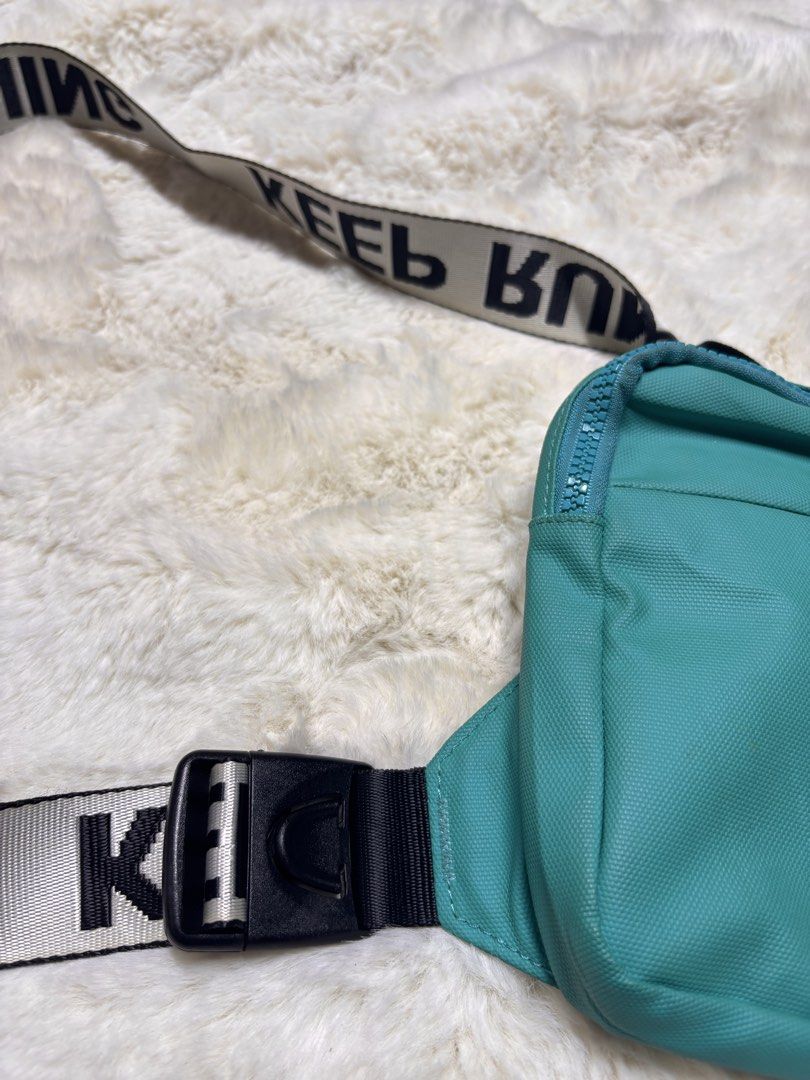 Teal Crossbody Bag with "KEEP RUNNING" Strap (Category: Cross-body Bags) located in Manila. Submitted by jeromskito66462 (Listing ID 1459980333, Image 2). Description: - Stylish teal crossbody bag - Features a black and white strap with "KEEP RUNNING" text - Main zippered compartment for secure storage - Front zippered pocket for quick access - Breathable mesh panel on the back - Adjustable strap with a convenient buckle closure - Ideal for every