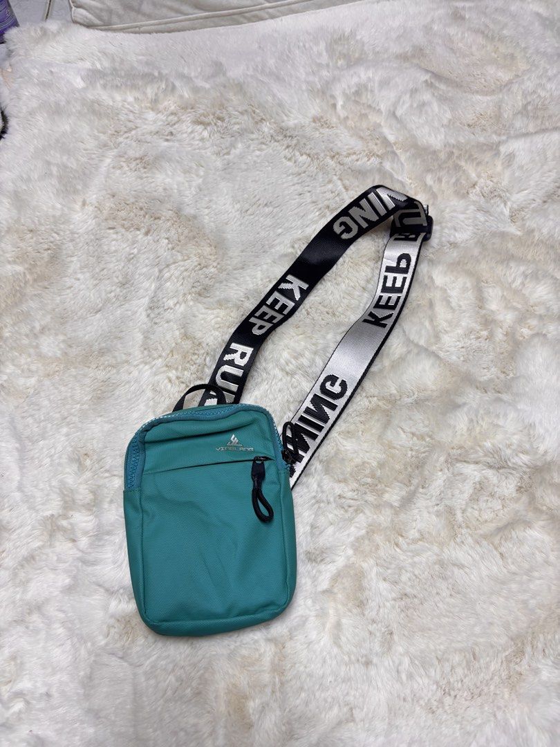 Teal Crossbody Bag with "KEEP RUNNING" Strap (Category: Cross-body Bags) located in Manila. Submitted by jeromskito66462 (Listing ID 1459980333, Image 1). Description: - Stylish teal crossbody bag - Features a black and white strap with "KEEP RUNNING" text - Main zippered compartment for secure storage - Front zippered pocket for quick access - Breathable mesh panel on the back - Adjustable strap with a convenient buckle closure - Ideal for every