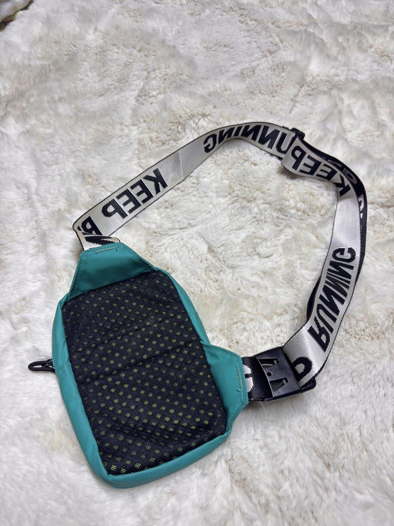Teal Crossbody Bag with "KEEP RUNNING" Strap (Category: Cross-body Bags) located in Manila. Submitted by jeromskito66462 (Listing ID 1459980333, Image 3). Description: - Stylish teal crossbody bag - Features a black and white strap with "KEEP RUNNING" text - Main zippered compartment for secure storage - Front zippered pocket for quick access - Breathable mesh panel on the back - Adjustable strap with a convenient buckle closure - Ideal for every