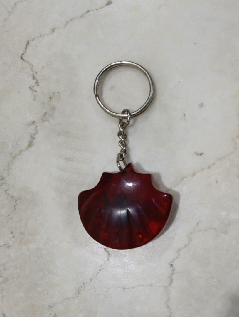 Thailand Souvenir Crab & Seashell Resin Keychain (Category: Travel Essentials & Accessories) located in Bulacan. Submitted by honhonliz (Listing ID 1460025549, Image 2). Description: Vintage souvenir keychain from Thailand. It features a real miniature crab, natural seashells, and small green decorative accents permanently encased in a glossy, fan-shaped deep red translucent epoxy resin pendant. The country name "Thailand" is neatly stamped in go