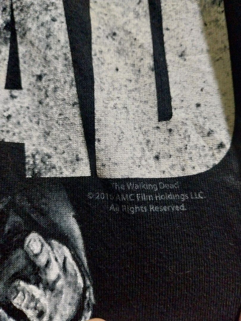 The Walking Dead AMC T-Shirt (Category: Tshirts & Polo Shirts ) located in Taguig. Submitted by lumangdamit (Listing ID 1460059506, Image 2). Description: - Black t-shirt with 'The Walking Dead' graphic - Features zombie hands reaching out design - Made by Keya USA - Perfect for fans of the show - Made from soft ring spun cotton -21x29 dimes.