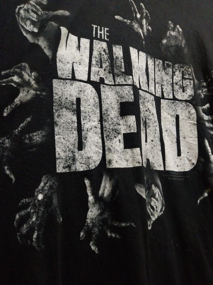 The Walking Dead AMC T-Shirt (Category: Tshirts & Polo Shirts ) located in Taguig. Submitted by lumangdamit (Listing ID 1460059506, Image 3). Description: - Black t-shirt with 'The Walking Dead' graphic - Features zombie hands reaching out design - Made by Keya USA - Perfect for fans of the show - Made from soft ring spun cotton -21x29 dimes.
