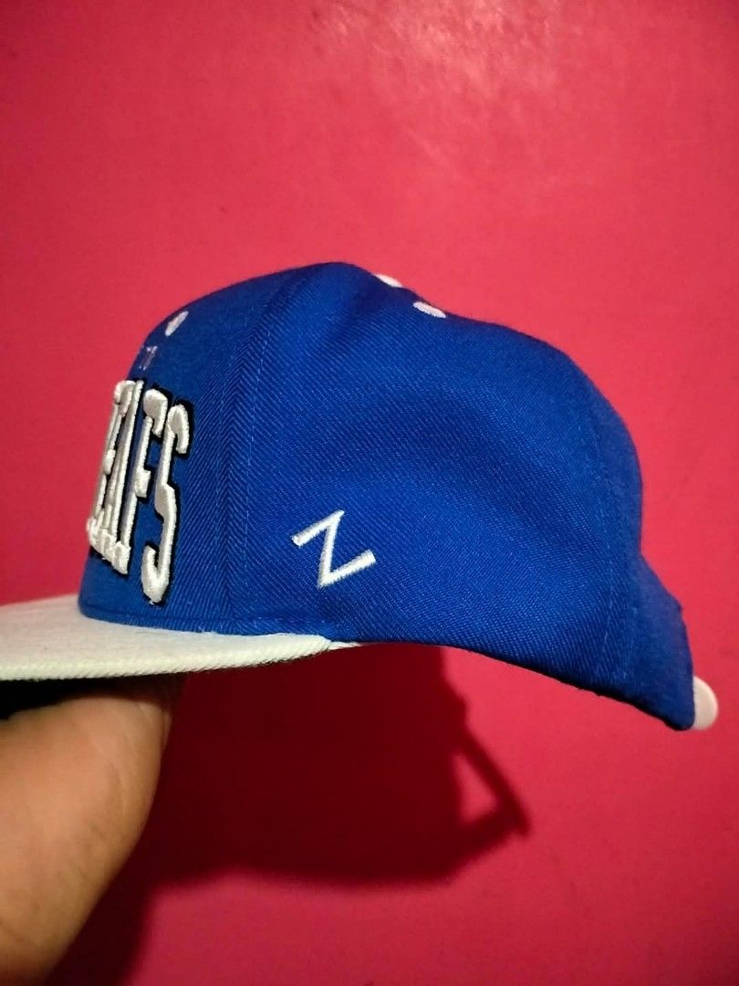 Toronto Maple Leafs Zephyr Snapback Hat NHL (Category: Caps & Hats) located in Mangaldan. Submitted by niftythrifty69 (Listing ID 1459960540, Image 3). Description: - Blue Toronto Maple Leafs snapback hat - White brim and front panel - Embroidered team name in white - Zephyr brand - NHL logo on the back - Adjustable strap - Ideal for any Maple Leafs fan.