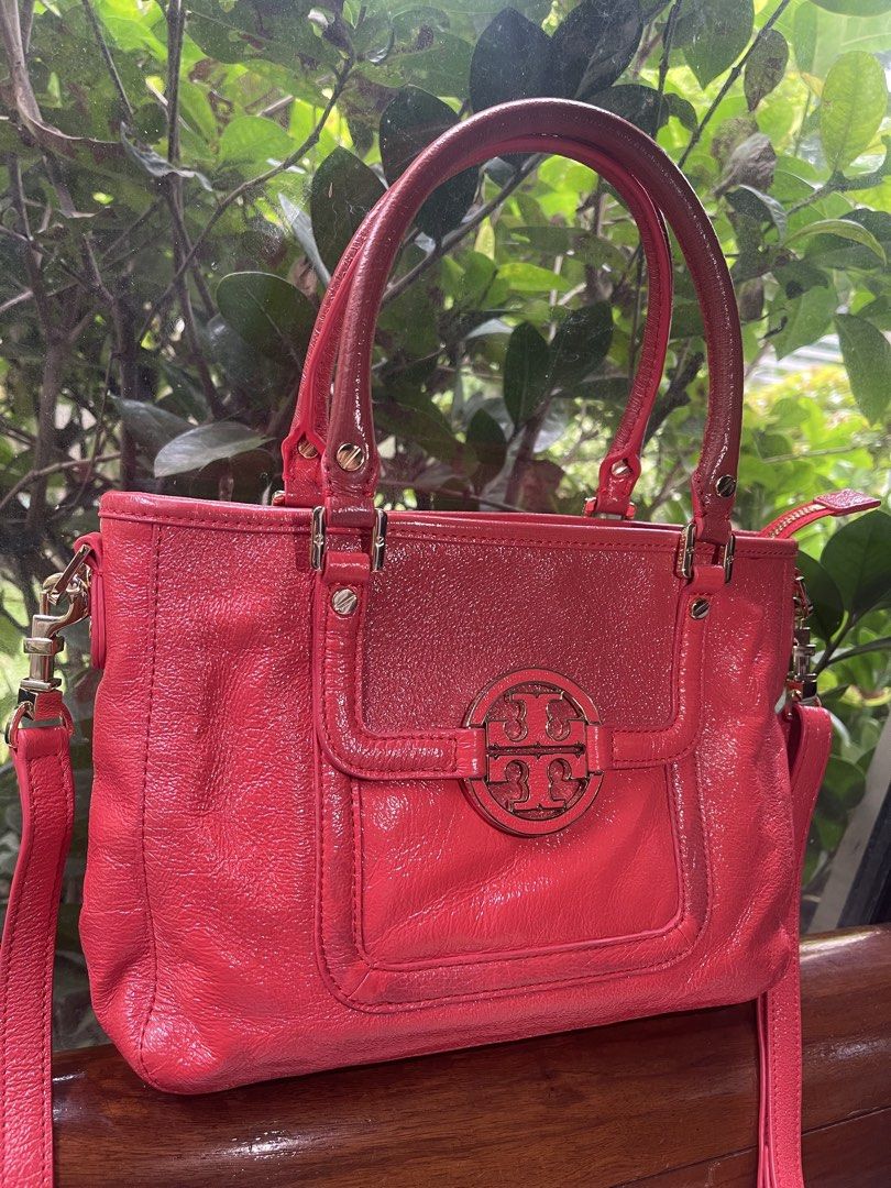 Tory Burch Amanda Red Leather Tote Bag Authentic (Category: Luxury Bags & Wallets) located in Santa Rosa. Submitted by denisequi (Listing ID 1459930569, Image 3). Description: - Genuine red cow leather with a sleek, shiny finish. - Iconic gold Tory Burch logo hardware. - Versatile carrying options: comfortable top handles and a detachable shoulder strap. - Secure zipper closure for the main compartment. - Ideal for both daily errands and evening 