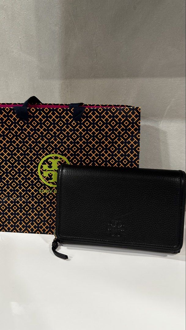 Tory Burch Black Leather Wallet with Chain and Strap (Category: Luxury Bags & Wallets) located in Rizal. Submitted by dumbchowdy (Listing ID 1460037719, Image 1). Description: - Genuine Tory Burch black pebbled leather wallet - Multiple interior card slots - Zippered compartments for secure storage - Detachable gold chain for clutch style - Adjustable black leather crossbody strap for hands-free wear - Includes original Tory Burch shopping bag - 
