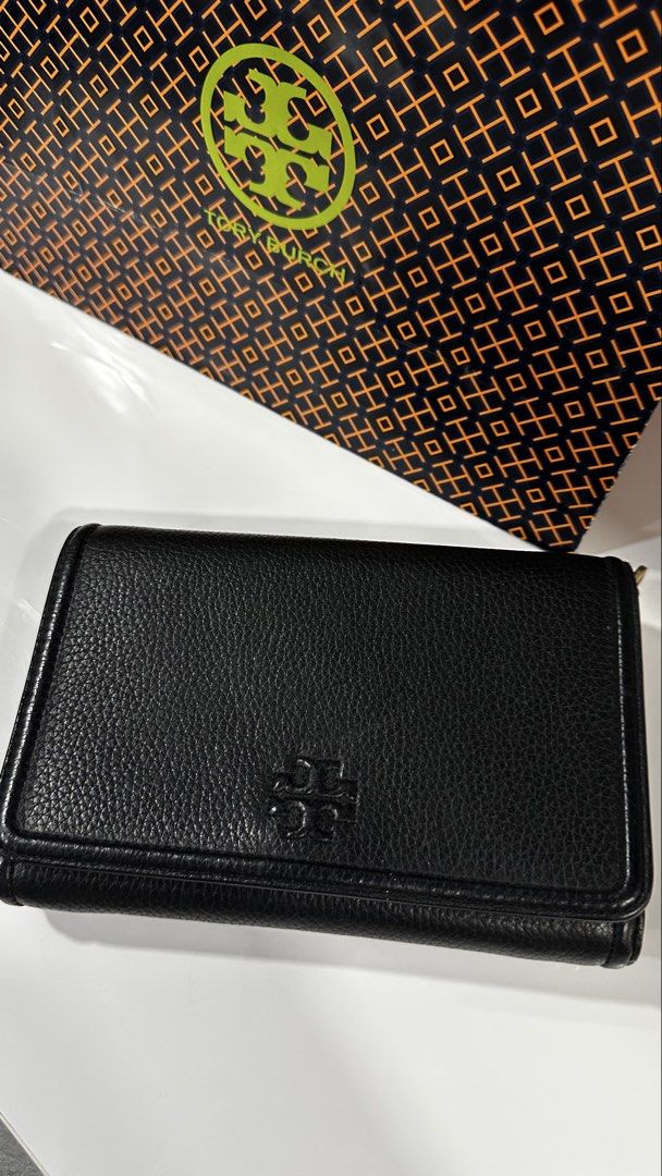 Tory Burch Black Leather Wallet with Chain and Strap (Category: Luxury Bags & Wallets) located in Rizal. Submitted by dumbchowdy (Listing ID 1460037719, Image 2). Description: - Genuine Tory Burch black pebbled leather wallet - Multiple interior card slots - Zippered compartments for secure storage - Detachable gold chain for clutch style - Adjustable black leather crossbody strap for hands-free wear - Includes original Tory Burch shopping bag - 