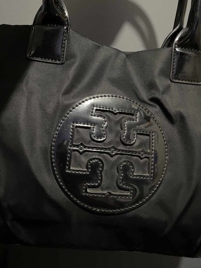 Tory Burch Black Nylon Tote Bag Medium size (Category: Shoulder Bags) located in Batangas. Submitted by bagstolove3.0 (Listing ID 1459990290, Image 3). Description: - Classic black Tory Burch tote bag - Durable nylon material - Iconic Tory Burch logo on front - Patent leather trim and handles for a stylish contrast - Spacious interior for daily essentials - Perfect for work or casual outings.