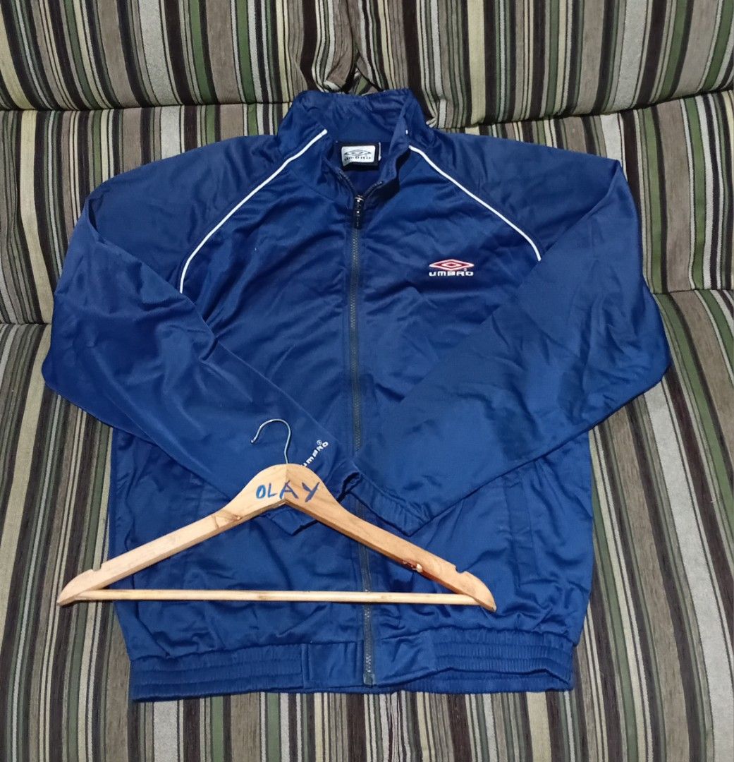 Umbro Navy Blue Track Jacket (Category: Coats, Jackets and Outerwear) located in Taguig. Submitted by conniemdcruz (Listing ID 1460085889, Image 1). Description: - Navy blue Umbro track jacket - Embroidered Umbro diamond logo on chest - White piping detail on shoulders and sleeves - Full zip closure - Elasticated cuffs and hem - Perfect for sports or casual wear Umbro Large 23x28 Excellent condition 500.