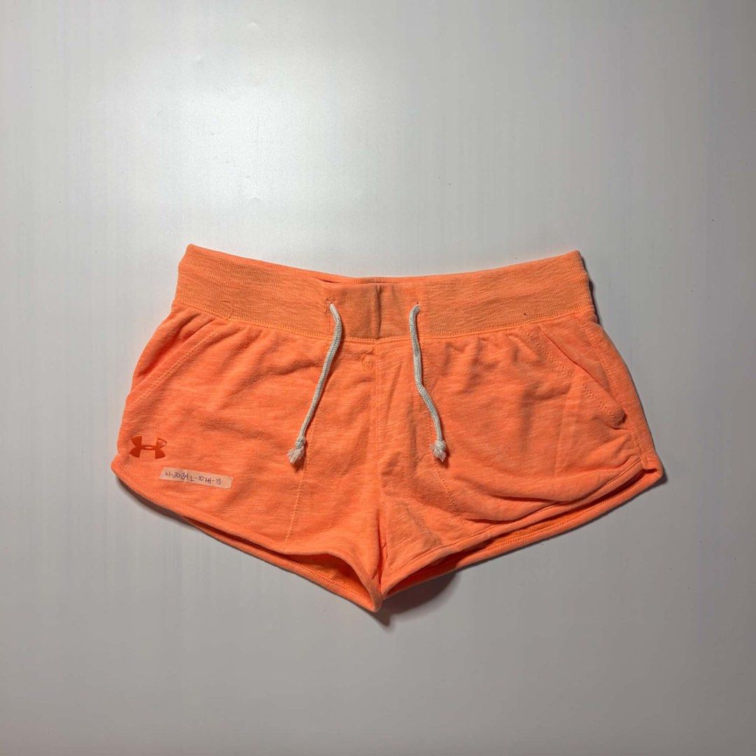 Under Armour Orange Athletic Shorts S-M (Category: Shorts) located in Baguio. Submitted by cosmogyralfinds (Listing ID 1460057397, Image 2). Description: - Orange Under Armour shorts - Size: S-M - Waist: 30-34 inches - Length: 10 inches - Hem: 13 inches - Ideal for workouts and lounging - Features a comfortable drawstring waist - Made with soft, breathable material - Perfect for an active lifestyle.