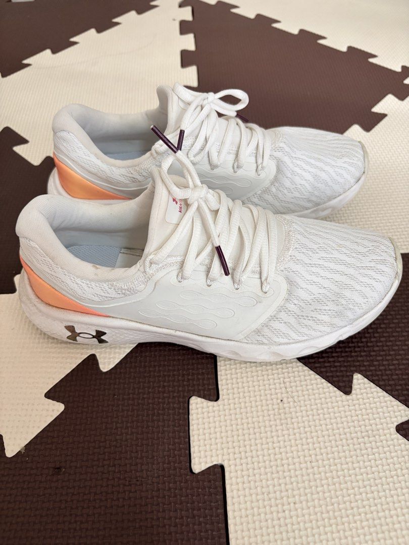 Under Armour White Running Shoes (Category: Sneakers) located in Mandaluyong City. Submitted by rhoxiebee (Listing ID 1459964622, Image 2). Description: -Under Armour Womens Charged Vantage 2 Running Shoes Sneakers Size: US 9 UK 6.5 EUR 40.5 CM 26 CHN 260(2) - Breathable mesh upper - Comfortable sole - Gradient pink and orange heel accent - White laces with subtle purple tips - Ideal for workouts and casual wear.