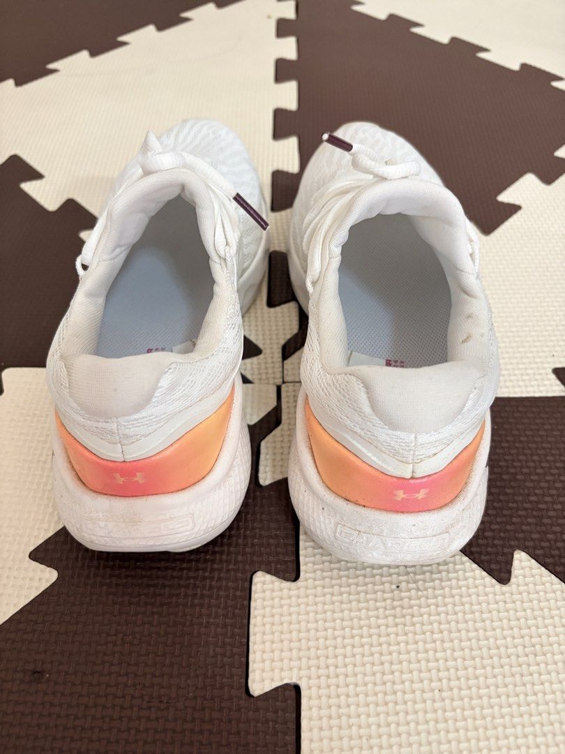 Under Armour White Running Shoes (Category: Sneakers) located in Mandaluyong City. Submitted by rhoxiebee (Listing ID 1459964622, Image 3). Description: -Under Armour Womens Charged Vantage 2 Running Shoes Sneakers Size: US 9 UK 6.5 EUR 40.5 CM 26 CHN 260(2) - Breathable mesh upper - Comfortable sole - Gradient pink and orange heel accent - White laces with subtle purple tips - Ideal for workouts and casual wear.