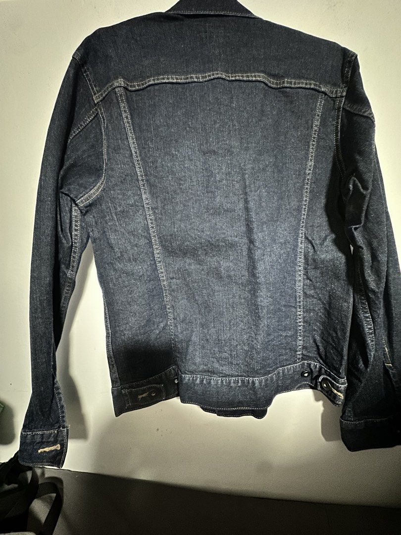 Uniqlo Denim Jacket Size M (Category: Coats, Jackets and Outerwear) located in Cavite. Submitted by yong_mountaineering (Listing ID 1460018084, Image 3). Description: - Classic dark wash denim jacket from Uniqlo - Button-up front closure - Two chest pockets - Button cuffs on sleeves - A versatile staple piece for any wardrobe.