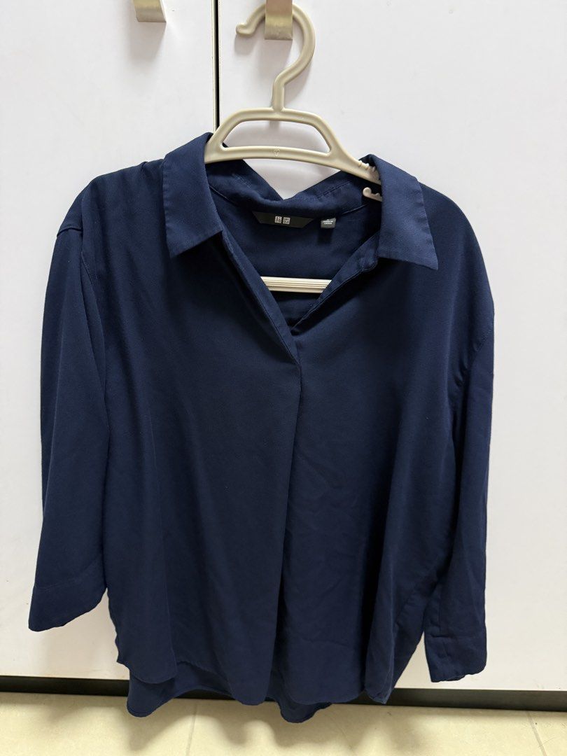 Uniqlo Navy Blue Collared Shirt (Category: Shirts) located in Quezon City. Submitted by yaniekl (Listing ID 1460067064, Image 1). Description: - Brand: Uniqlo - Color: Navy Blue - Neckline: Collared with V-cut opening - Sleeves: Three-quarter length - Fit: Relaxed - Style: Versatile for casual or work attire - Pairing: Easy to match with various outfits.