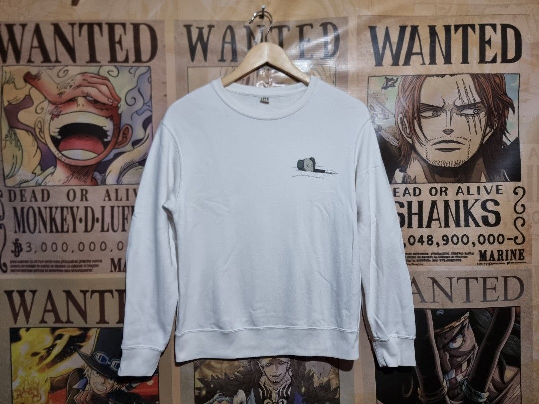 UNIQLO x KAWS Longsleeve Sweatshirt (Category: Longsleeves) located in Imus. Submitted by aim_for_less (Listing ID 1460067656, Image 1). Description: UNIQLO X KAWS LONGSLEEVE SWEATSHIRT - Size: (150) Kids on tag BUT can fit to women - DIMES: 19.5" X 24" - White long-sleeved sweatshirt - Features a small KAWS character graphic on the front left chest - Large KAWS character graphic on the back - Made from soft, comfortable material - Perfect for ca