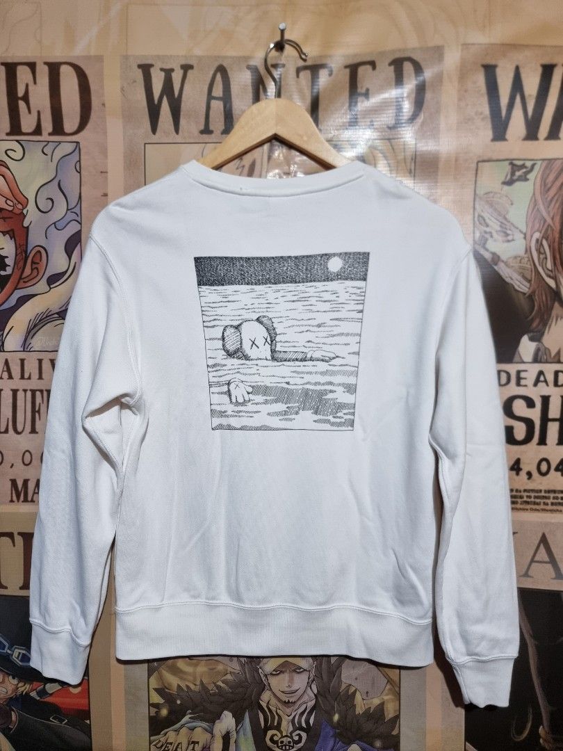 UNIQLO x KAWS Longsleeve Sweatshirt (Category: Longsleeves) located in Imus. Submitted by aim_for_less (Listing ID 1460067656, Image 3). Description: UNIQLO X KAWS LONGSLEEVE SWEATSHIRT - Size: (150) Kids on tag BUT can fit to women - DIMES: 19.5" X 24" - White long-sleeved sweatshirt - Features a small KAWS character graphic on the front left chest - Large KAWS character graphic on the back - Made from soft, comfortable material - Perfect for ca