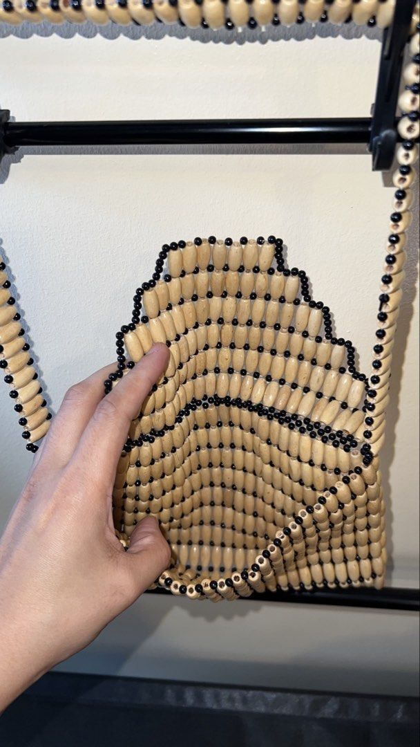 Unique Beaded Envelope Bag with Handle (Category: Clutches) located in Mandaluyong City. Submitted by chelseayb47224 (Listing ID 1459982891, Image 3). Description: - Unique envelope-style bag - Never used - Covered in wooden beads with black accents - Features a beaded handle - Ideal as a statement piece - Perfect for carrying essentials - Approximate dimensions: 8 inches wide x 6 inches tall.