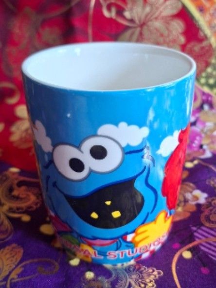 Universal Studio Sesame Street Mug (Category: Coffee & Tea Tableware) located in Consolacion. Submitted by luxekerei (Listing ID 1456813421, Image 3). Description: - Universal Studios Japan Sesame Street Elmo souvenir ceramic mug featuring a unique ABC block handle..