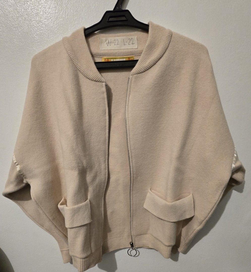 UTTI Beige Zip-Up Cardigan with Pockets (Category: Coats, Jackets and Outerwear) located in Quezon City. Submitted by ShoesManila (Listing ID 1460092346, Image 2). Description: UTTI cardigan Width 22 Length 22 Co Condition: Excellent No issue - Cozy beige zip-up cardigan - Two front pockets for convenience - Ribbed cuffs and hem for a snug fit - Stylish ring pull zipper - Subtle ribbon details on sleeves - Ideal for layering and casual wear Ready