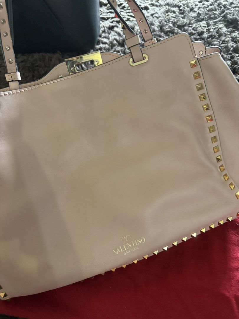 Valentino Beige Leather Medium Rockstud Trapeze Tote (Category: Luxury Bags & Wallets) located in Antipolo. Submitted by pinkktopaz (Listing ID 1459986387, Image 2). Description: Like new, minor folds/creases from storage but barely used With original dust bag and authenticity cards Slightly negotiable.