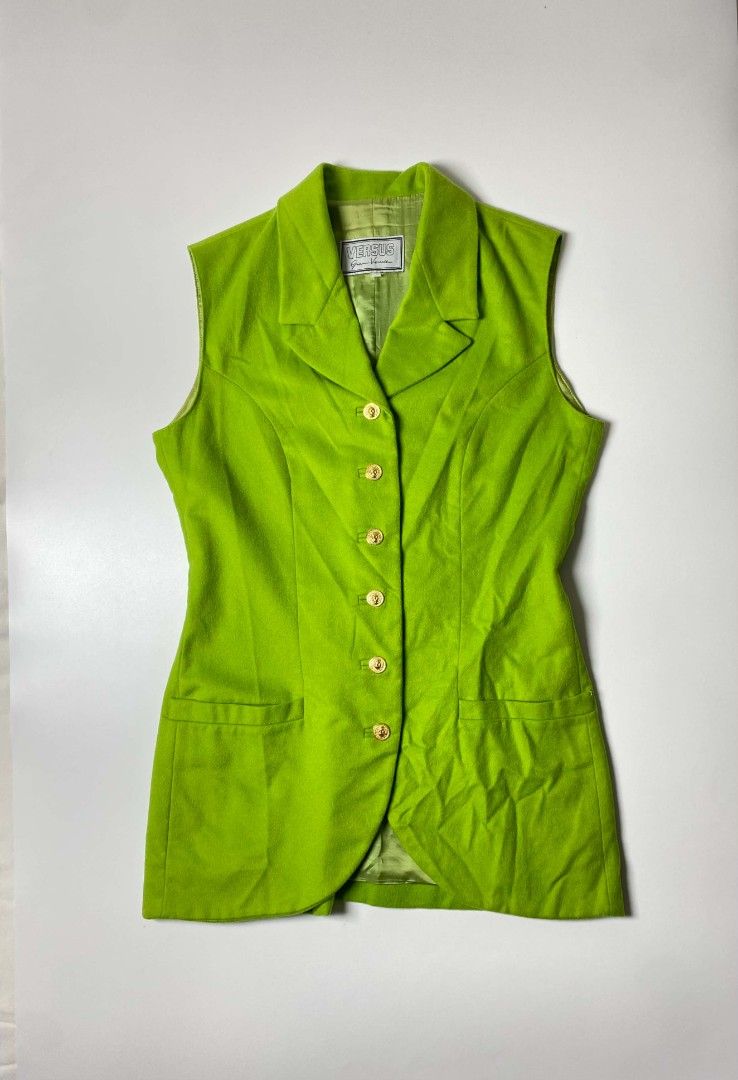 VERSACE VERSUS WOOL WAISTCOAT (Category: Others Tops) located in Balanga. Submitted by dig_gear (Listing ID 1459938235, Image 1). Description: GIANNI VERSACE VERSUS WOOL WAISTCOAT This vintage Versus Gianni Versace waistcoat is crafted from a vibrant lime green wool fabric, structured with princess seams to create a highly tailored, longline silhouette. It features a sophisticated notched collar, a classic lapel, two horizontal welt hip pockets, 